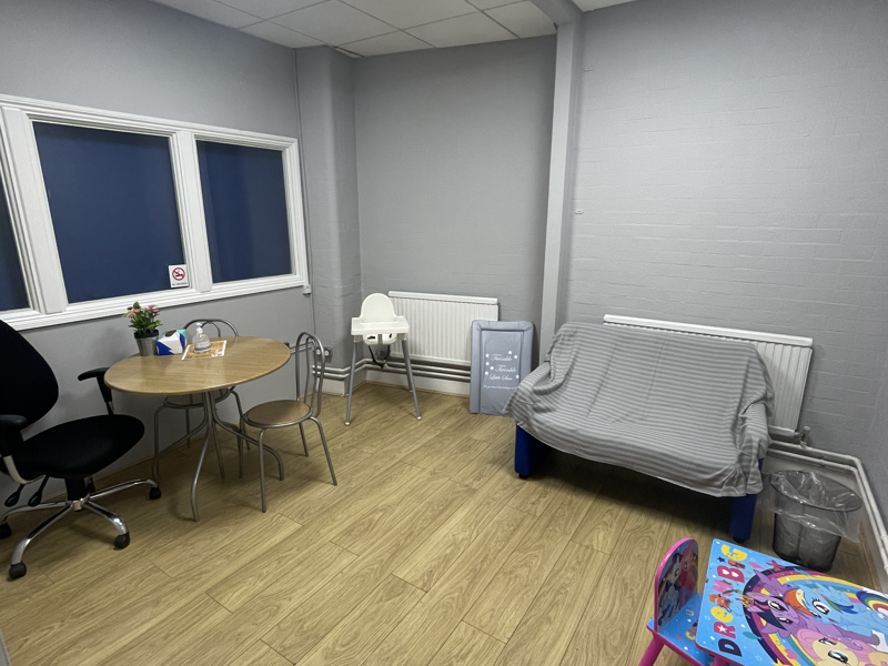 room with children's play toys, sofa and tv 